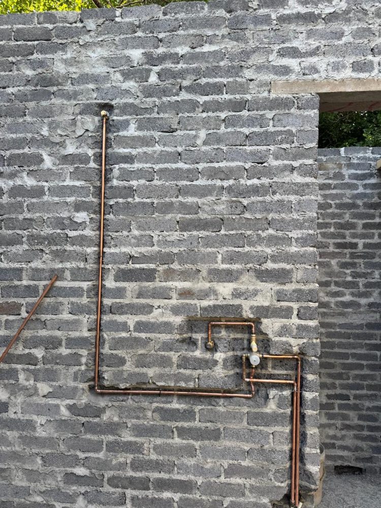 Neat copper pipework on a block wall